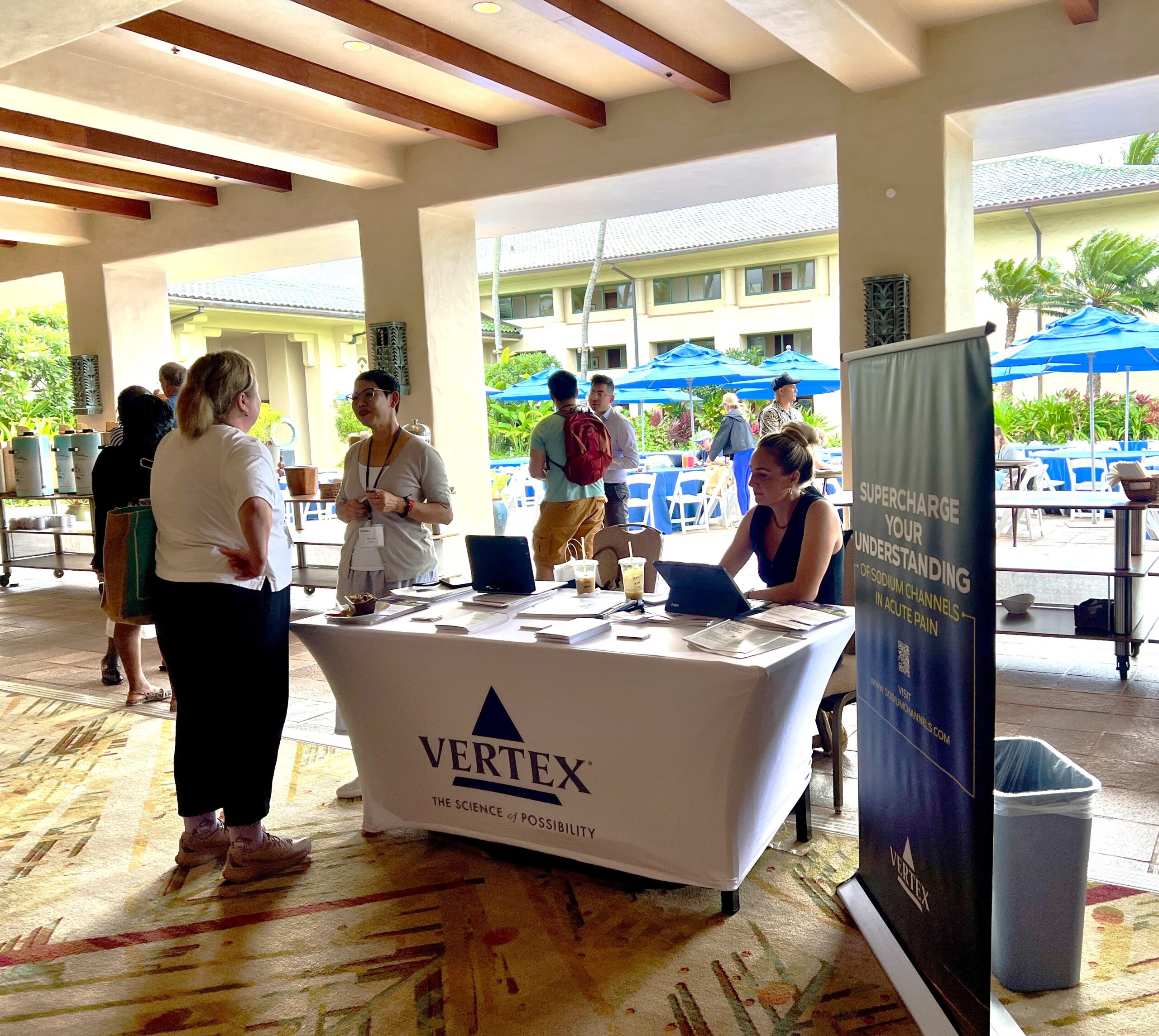 An exhibitor talking with attendees at a CSA conference