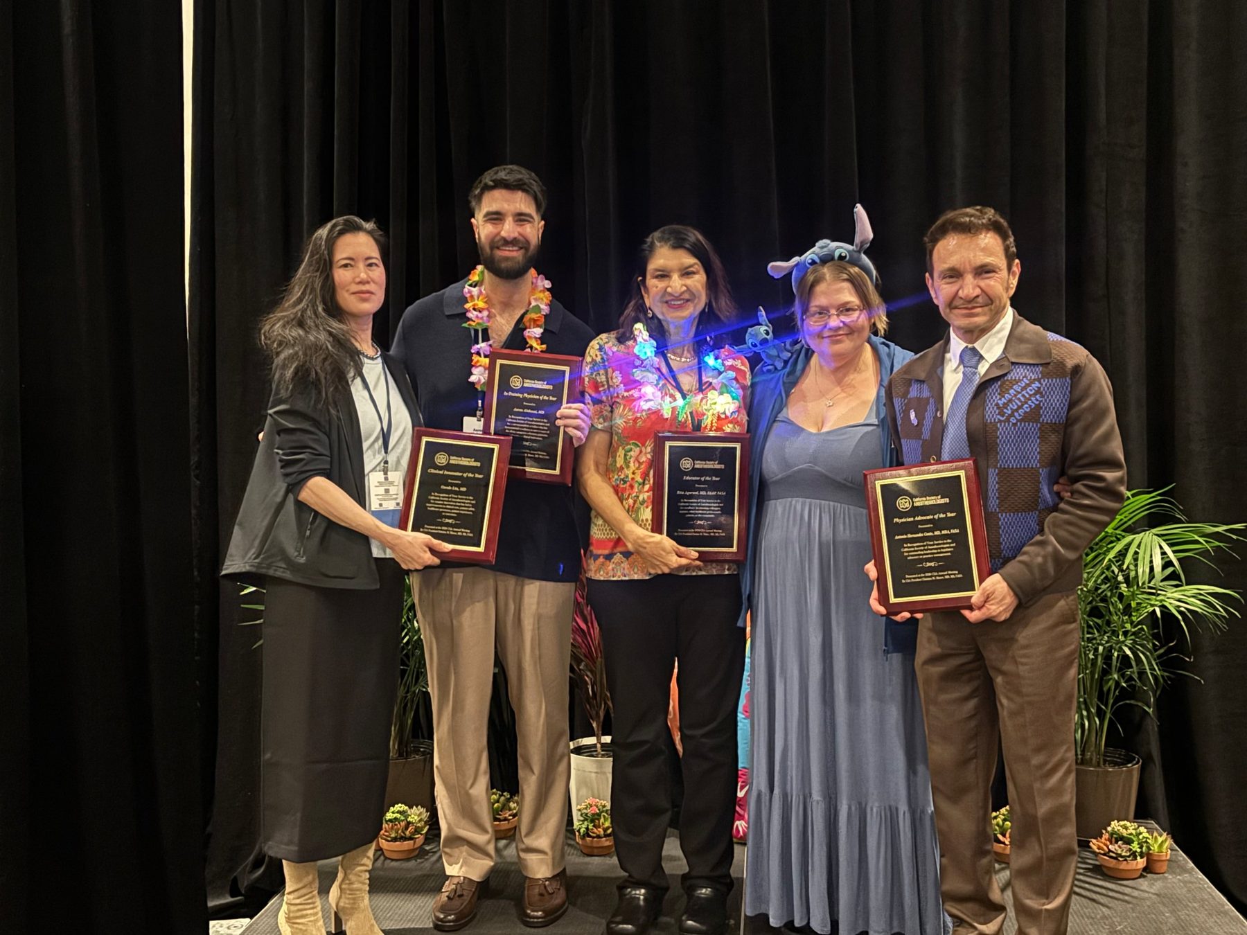 CSA award recipients holding their plaques