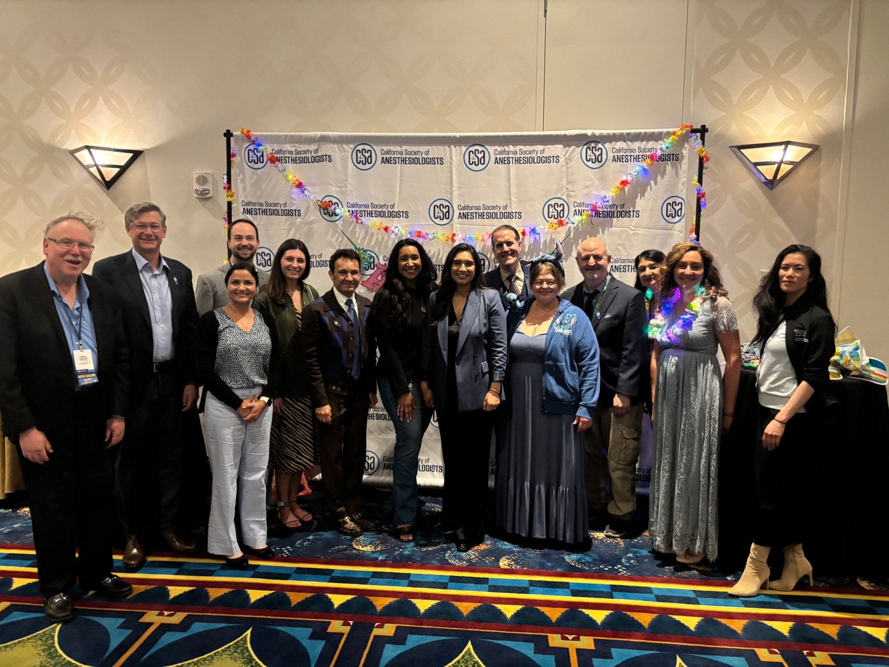 CSA members gathered at the CSA photo backdrop